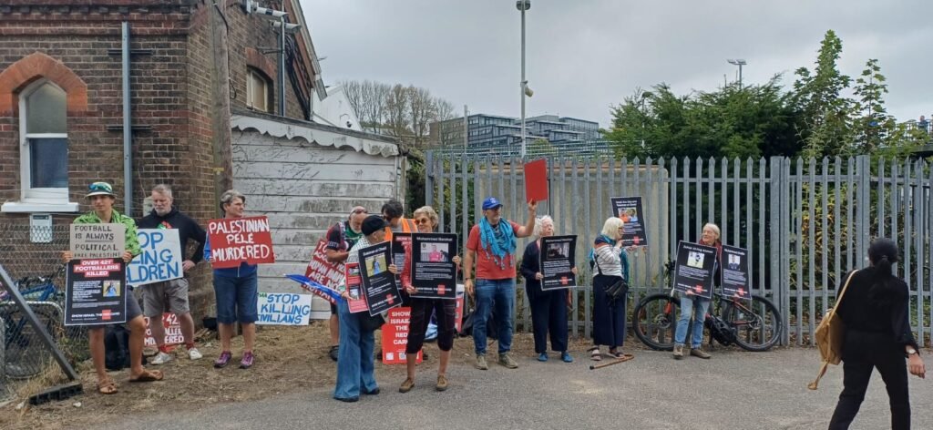 Seagulls Against Apartheid Show Israel The Red Card protest at Falmer Station. A gathering of up to 30 people held up placards with names of just a small number of the 421* footballers killed by Israel over the past 23 months. Photo Anthony Brambilla